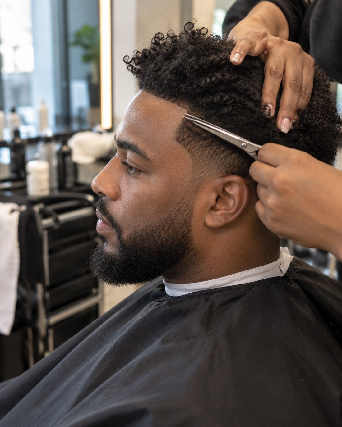 A hair system blended into a client's own hairline at the temple
